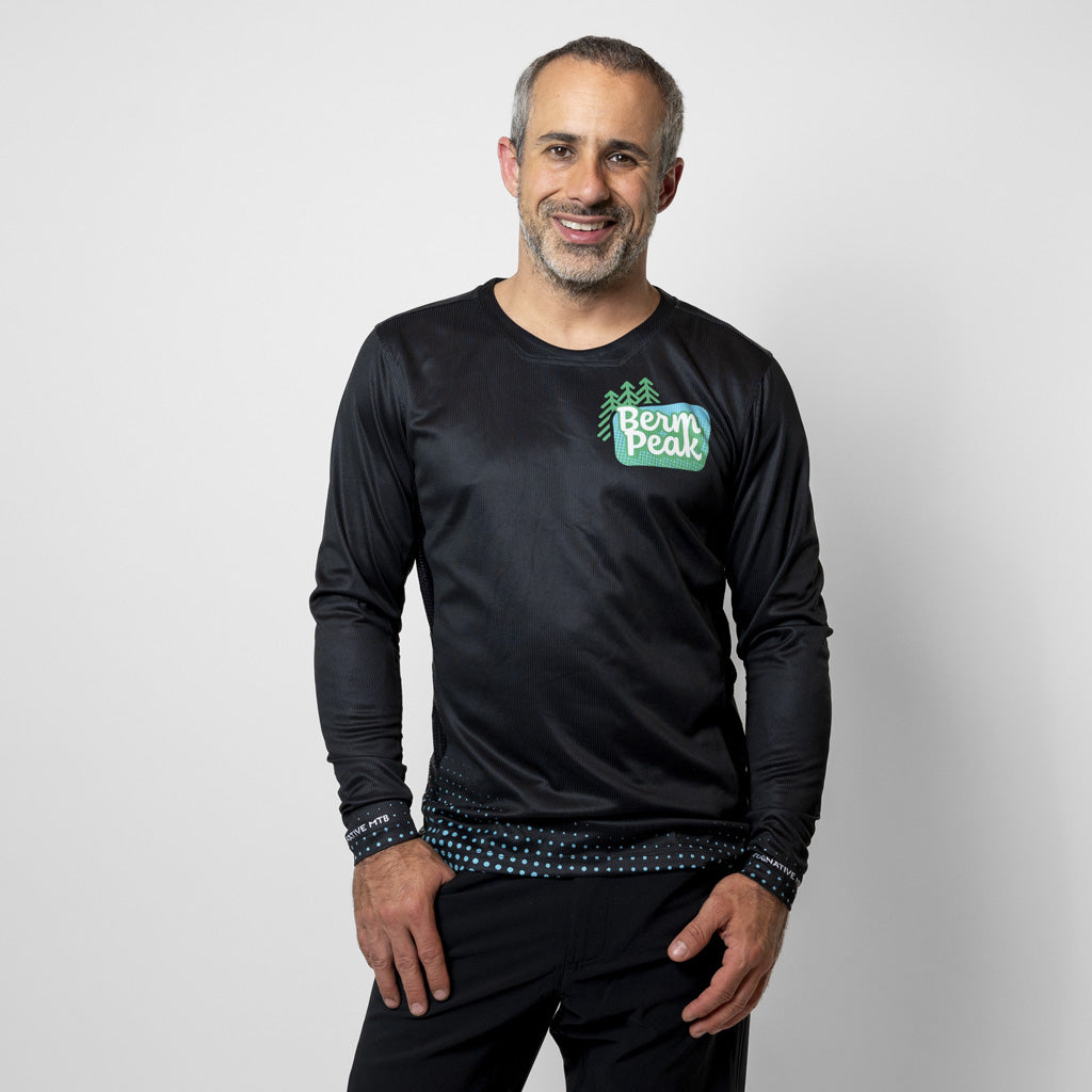 Seth Alvo of Berm Peak wearing the Men's Berm Peak Gravity MTB jersey on the trail
